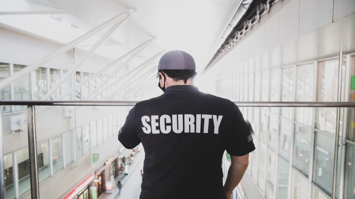 How Security Can Reduce Liability and Insurance Risks for Denver Properties Security guard on duty in modern building