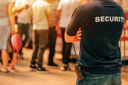 Security guard monitoring crowd at event